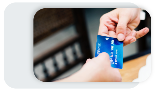 credit card being handed to another individual