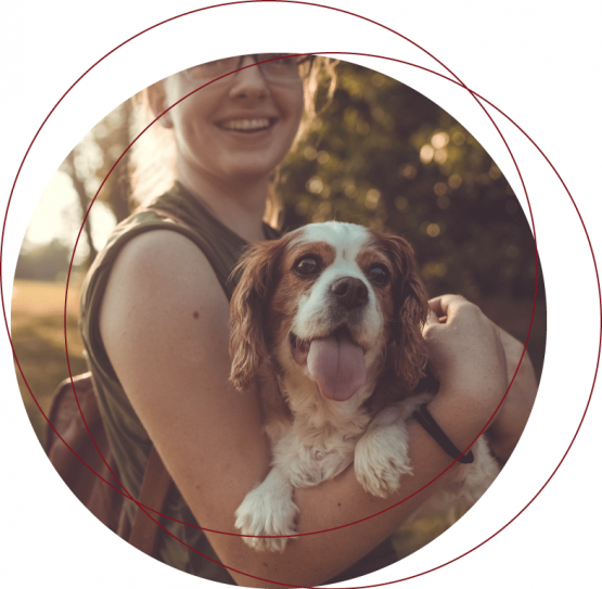 PD_Home_2-1 woman smiling and holding a dog